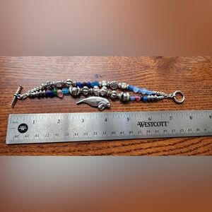 Silver bracelet with silver and glass beads and manatee charm